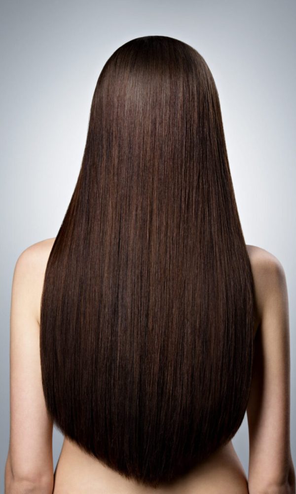 Rear Portrait of  woman with long brown straight  hair at studio